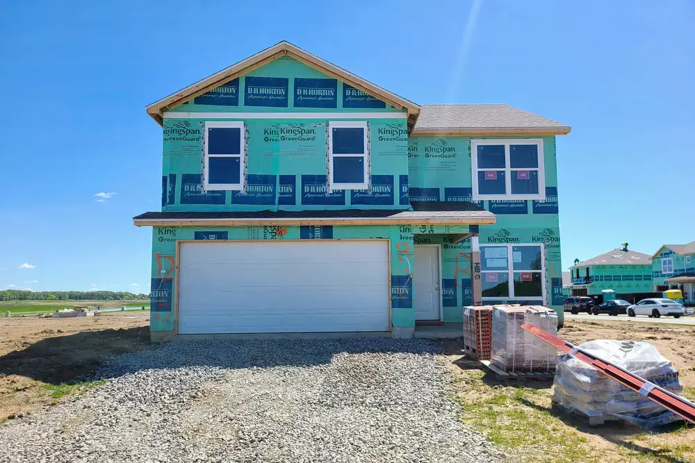 house under construction with gravel driveway